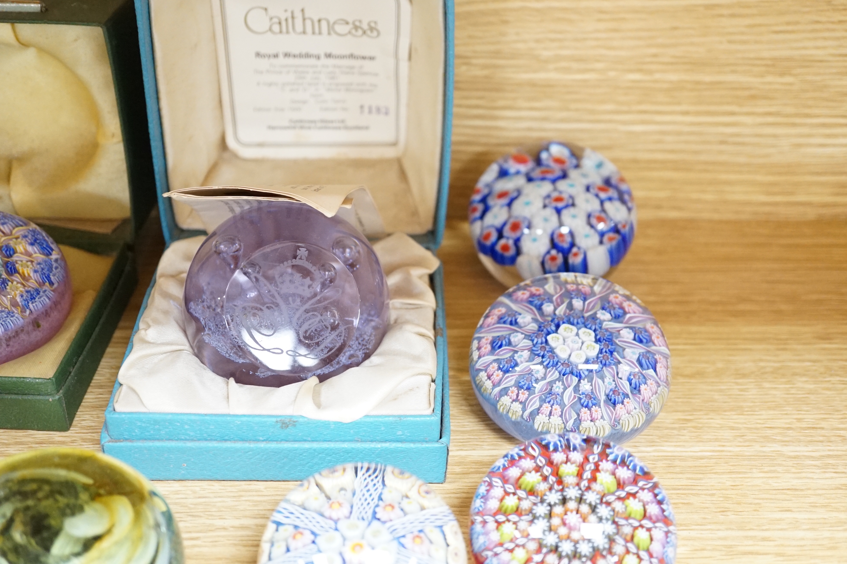 A collection of coloured glass paperweights including Strathearn, Caithness (28)
